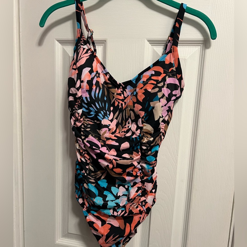 Women’s size medium one piece bathing suit by aqua green. New with tags.